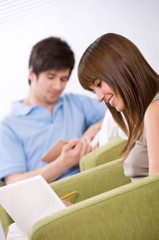 Student - two teenager reading book in lounge