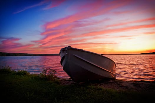 Image of fishing boat on shore of lake a