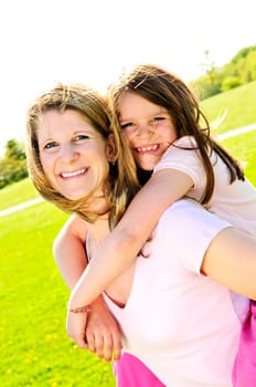 Mother and daughter piggyback