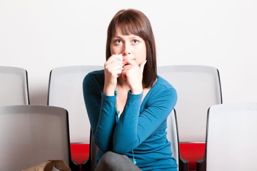 sad young woman holding tissue on her face