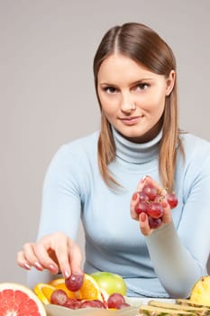 woman with red grapes
