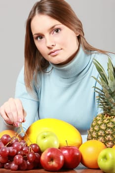 woman with red grapes