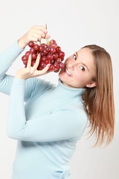 woman with red grapes