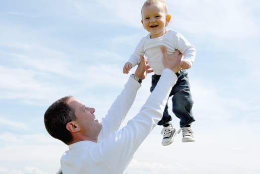 Proud Father - Holding Up Child -