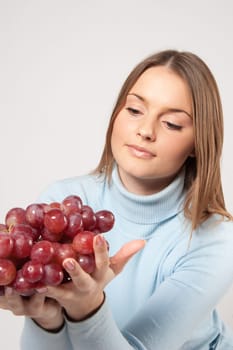 woman with red grapes