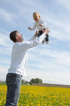 Proud father -throwing child up-