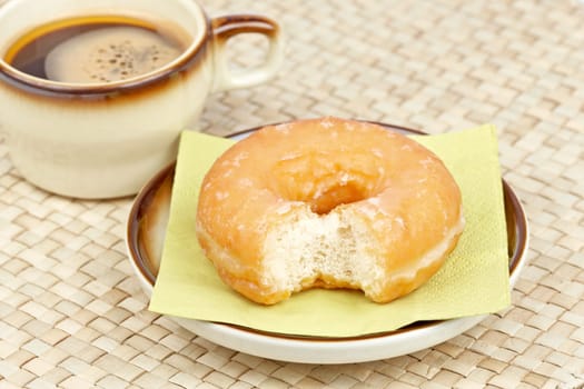 Donut bitten and coffee