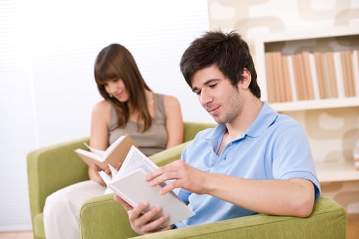 Student - two teenager reading book in lounge
