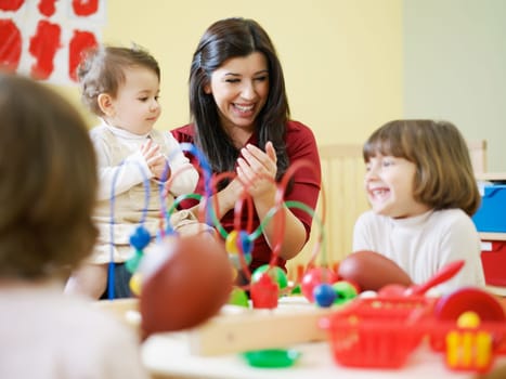 three little girls and female teacher in