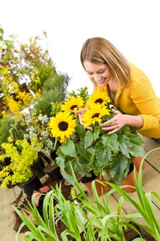 Gardening - portrait of smiling woman with sunflowers