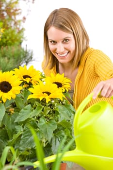 Gardening - woman pouring water to flowers
