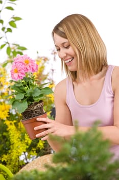 Gardening -  woman holding flower pot with flower