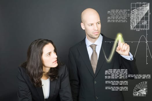 Business couple pressing virtual screen