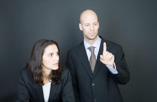 Business couple pressing virtual screen