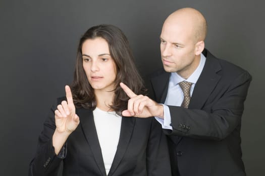 Business couple pressing virtual screen