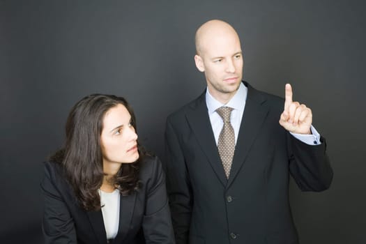 Business couple pressing virtual screen