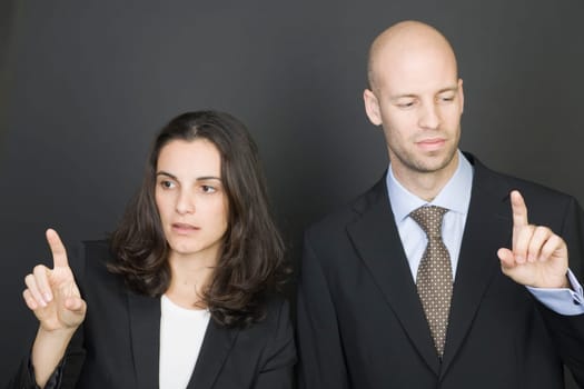 Business couple pressing virtual screen