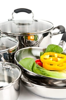 Stainless steel pots and pans with vegetables