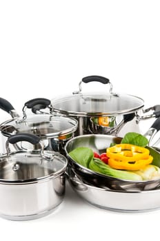 Stainless steel pots and pans with vegetables
