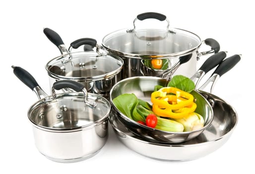 Stainless steel pots and pans with vegetables