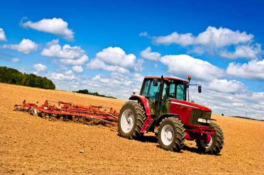 Tractor in plowed field