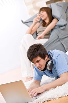 Student - Happy teenager with laptop and headphones