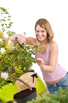 Gardening - woman cutting tree with pruning shears