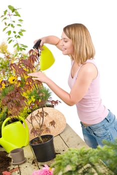 Gardening - woman sprinkling water to flowers