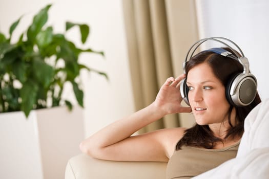 Woman with headphones listen to music in lounge