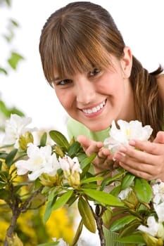 Gardening - Portrait of woman with Rhododendron flower