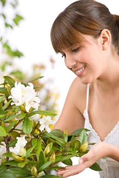 Gardening - Portrait of woman with Rhododendron flower