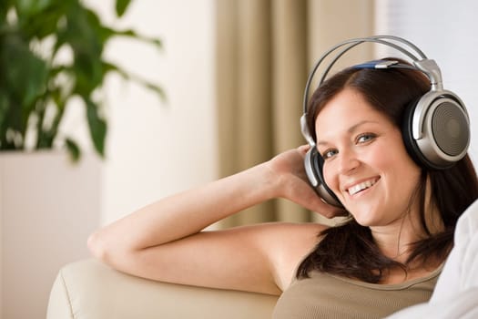 Woman with headphones listen to music  in lounge