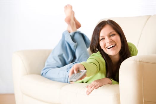 Cheerful woman switch television in living room