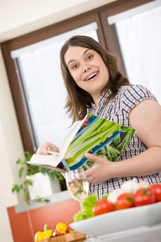 Cook - Plus size happy woman holding cookbook