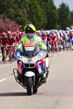 Competitors and following teams in the Giro dItalia passing by on a polderroad i