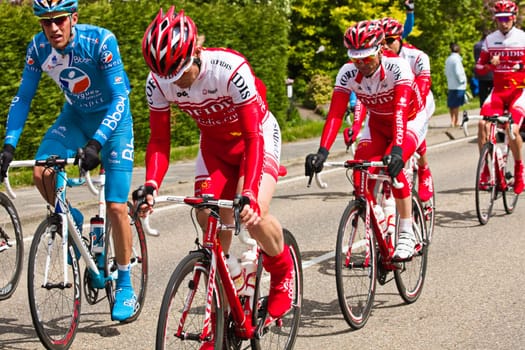 Competitors and following teams in the Giro dItalia passing by on a polderroad i
