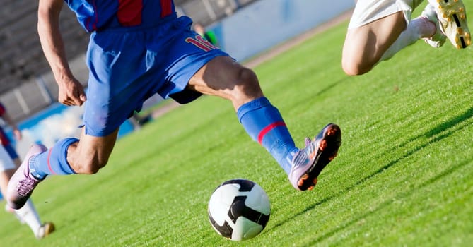 Soccer players fighting for the ball