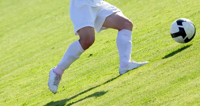 Soccer players fighting for the ball