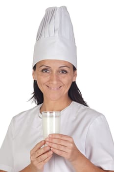 Pretty cook girl with a glass of milk