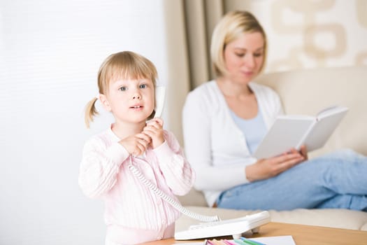 Little girl on phone in living room