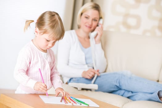 Little girl draw with color pencil in lounge