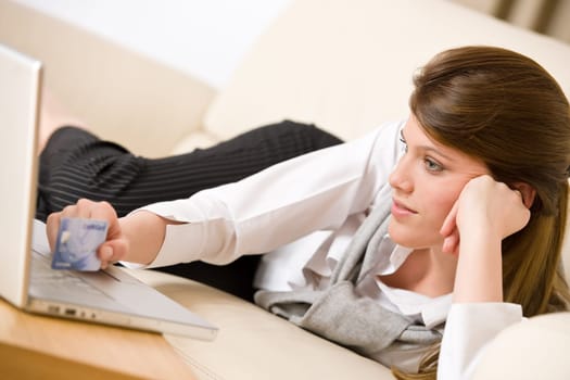 Home shopping - woman with credit card and laptop
