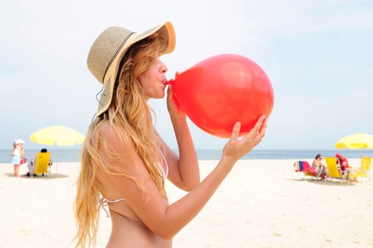 Woman with balloon on the beach