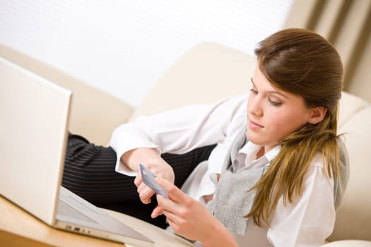 Home shopping - woman with credit card and laptop