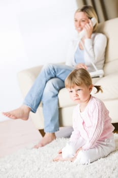 Mother and child in living room watch television