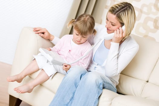 Mother and child - on the phone in living room