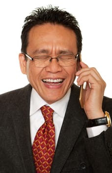 Businessman laughing while talking on the phone