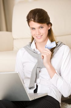 Home shopping - woman with credit card and laptop