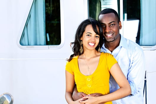 Happy couple in front of yacht