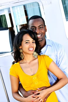 Happy couple in front of yacht